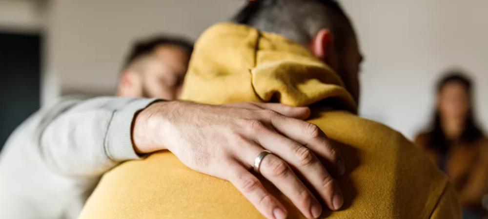 CIOB Man embracing his friend who is sharing a personal story 1000.jpg