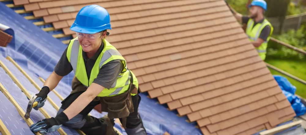 CIOB Female roofing technician installing new tiles 1000 .jpg