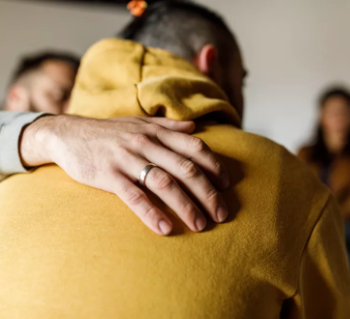 CIOB Man embracing his friend who is sharing a personal story 350.jpg