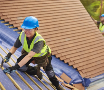 CIOB Female roofing technician installing new tiles 350 .jpg